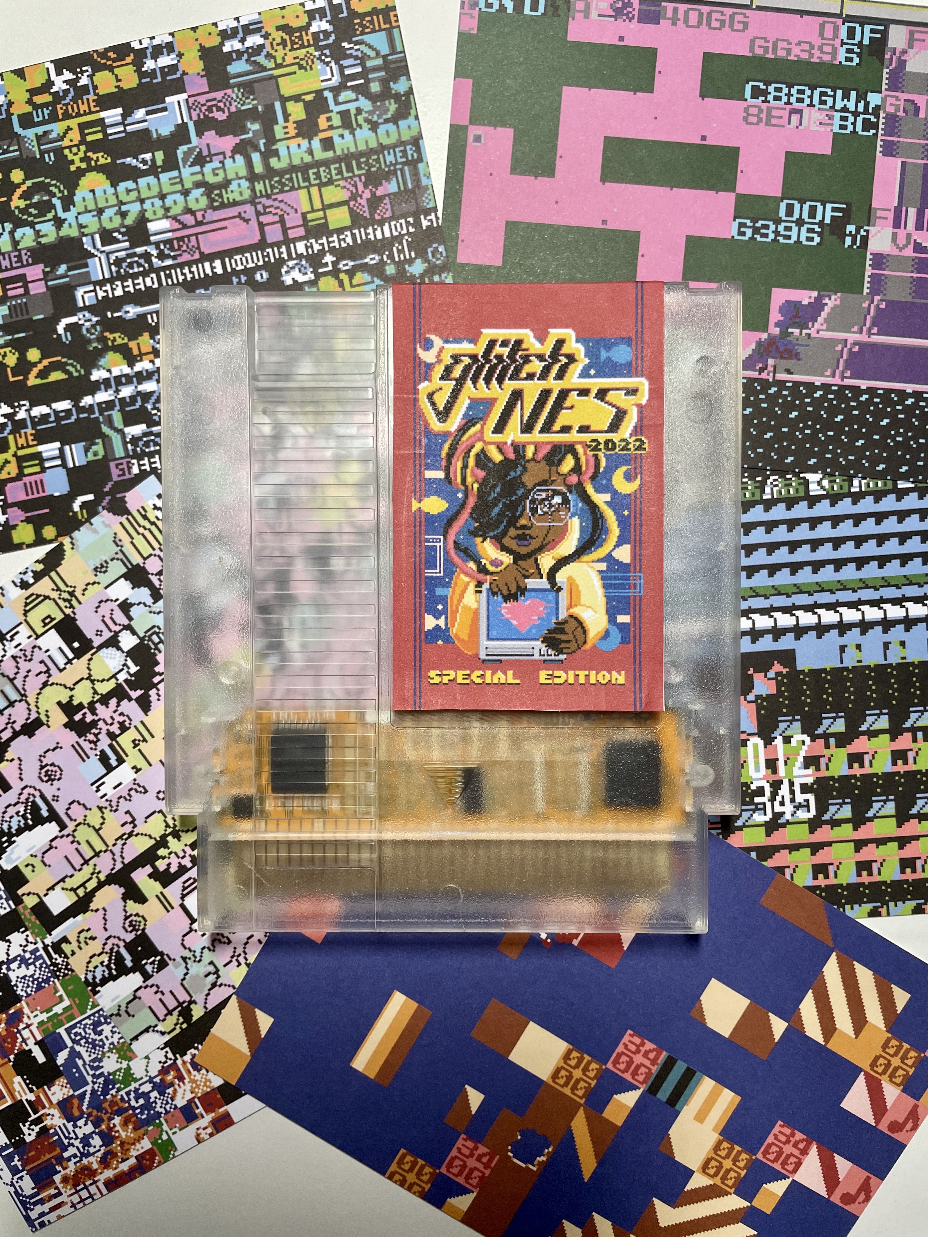 glitchNES 2022 with final label mockup and glitch post cards pictured behind