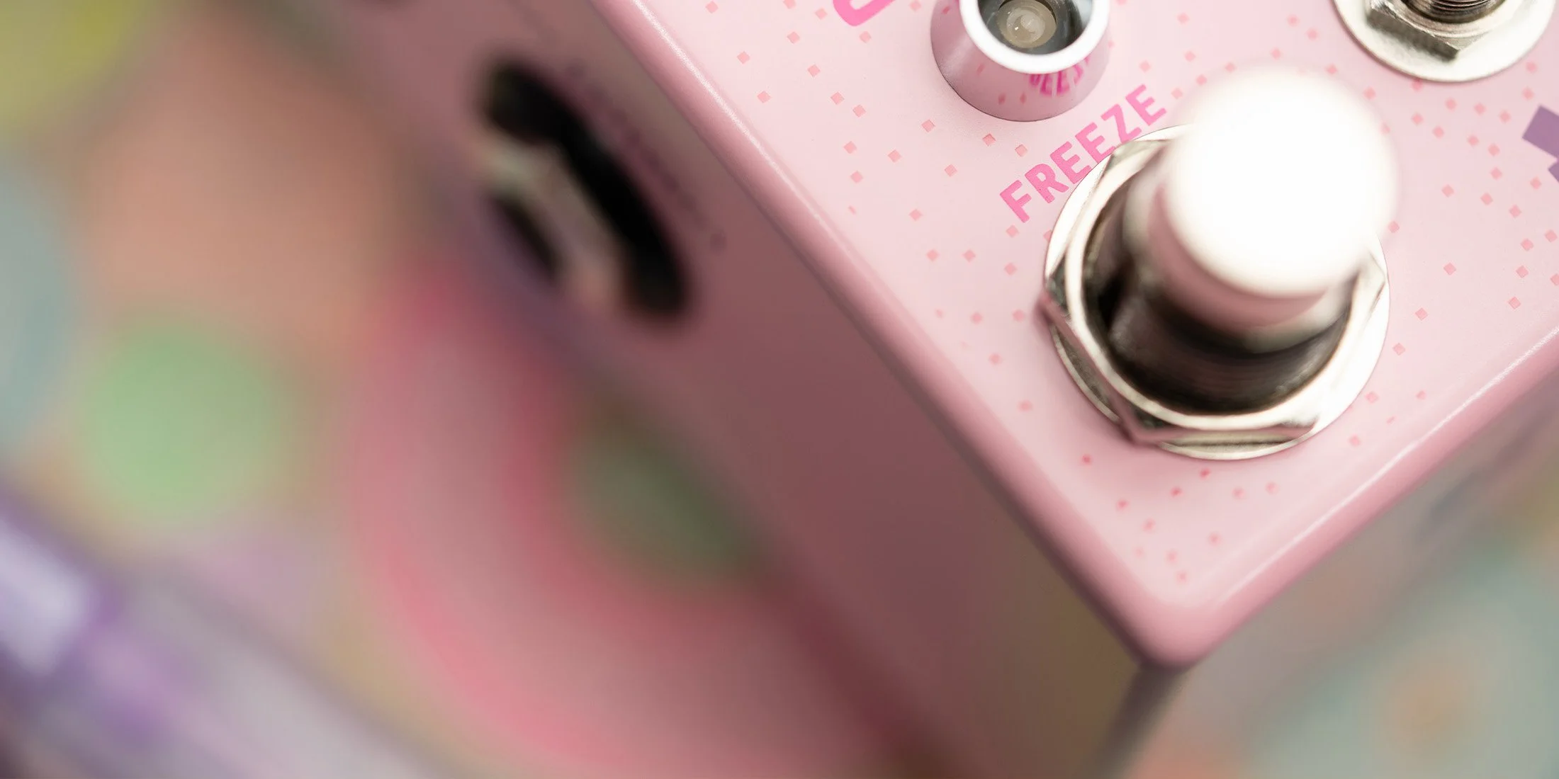 Lossy effects pedal by Chase Bliss and Goodhertz. Close up on Freeze stomp switch.