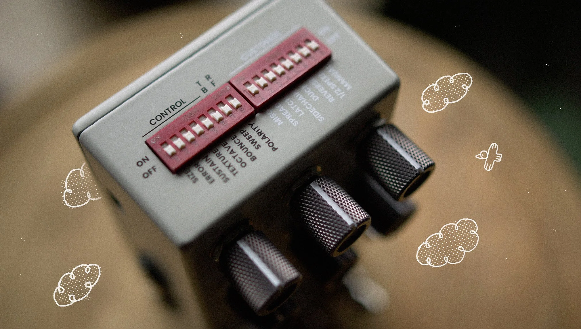 Top dip switch view of an Onward effects pedal by Chase Bliss surrounded by white chalk doodles.