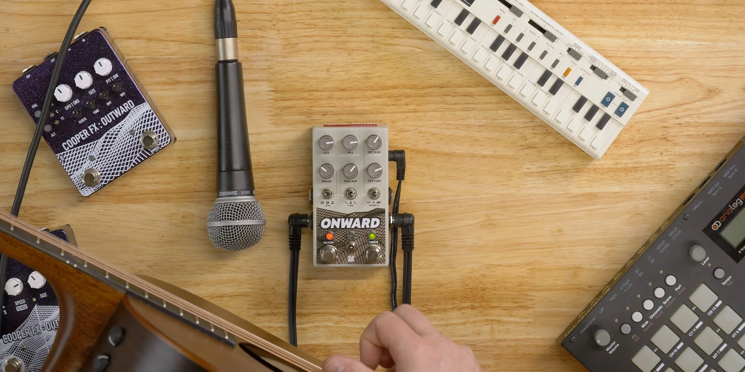 Onward on a table next to various musical equipment.