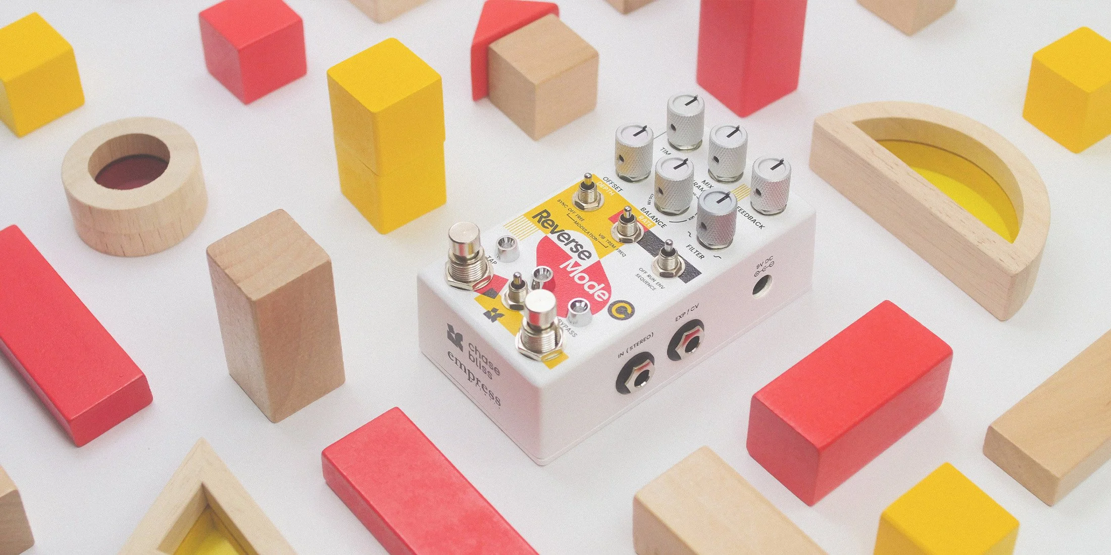 Reverse Mode C effects pedal by Chase Bliss surrounded by toy blocks.